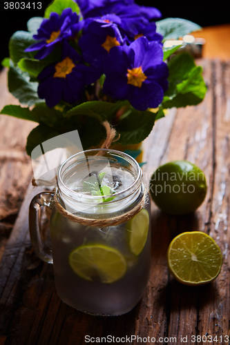 Image of fresh mojito on a rustic table.