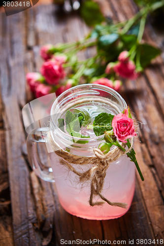 Image of fresh mojito on a rustic table.