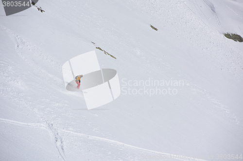 Image of freeride skier skiing in deep powder snow