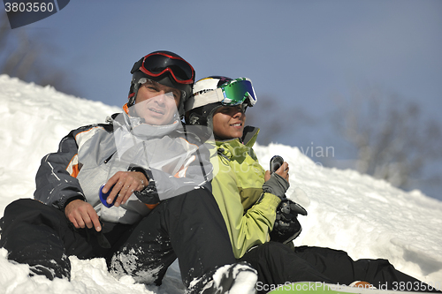 Image of snowboarders couple relaxing