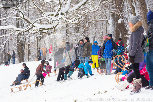 Image of Winter fun, snow, family sledding at winter time.