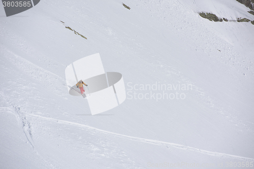 Image of freeride skier skiing in deep powder snow