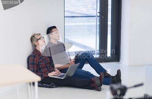 Image of startup business, couple working on laptop computer at office