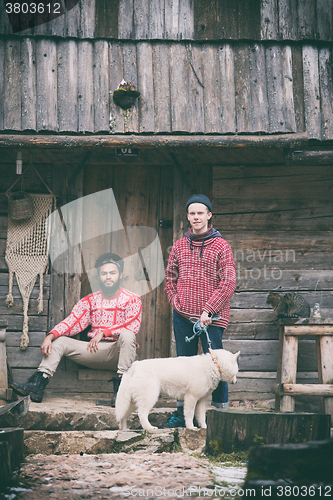 Image of frineds together in front of old wooden house