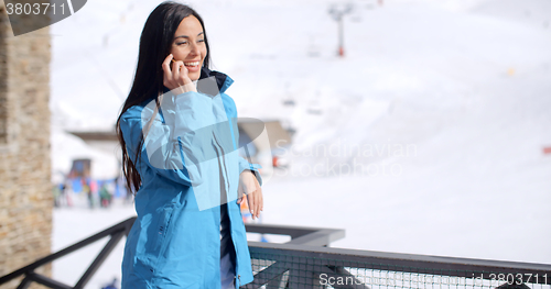 Image of Attractive young woman at a mountain ski resort