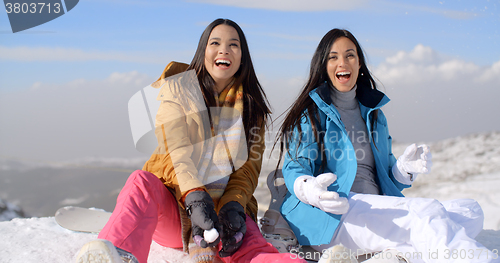 Image of Two gorgeous laughing young woman in snow