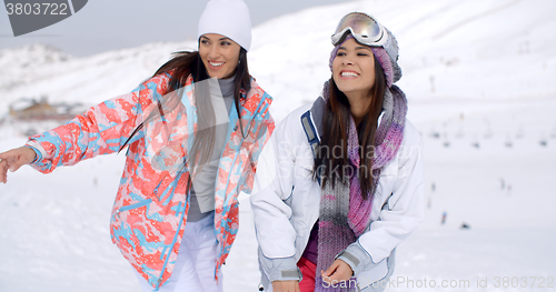 Image of Two pretty young female friends at a ski resort