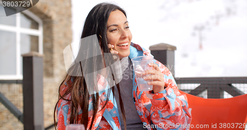 Image of Young woman chatting on her mobile