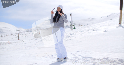 Image of Attractive young woman standing in winter snow