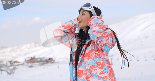 Image of Happy skier pulling back hair