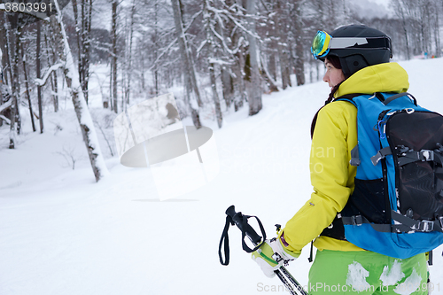 Image of Female skier standing on background beautiful landscape of snowy mountains.