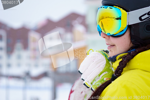 Image of Female snowboarder standing with snowboard