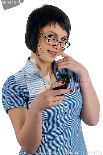 Image of Pretty woman smiles with phone in hand