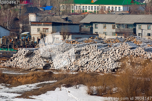 Image of pile of wood logs on plywood combine. Tyumen