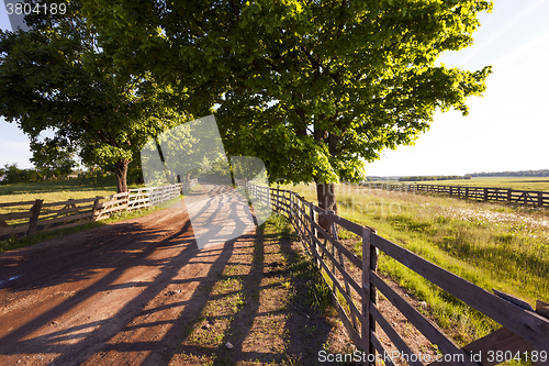 Image of rural road .  fence