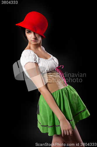 Image of Pretty girl in german style dress with red hat