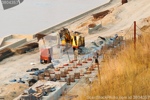 Image of Excavator on pedestrian quay construction. Tyumen