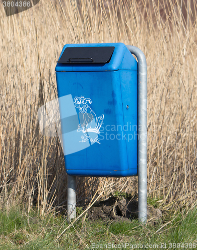 Image of Close up of bright blue dog mess poop bin