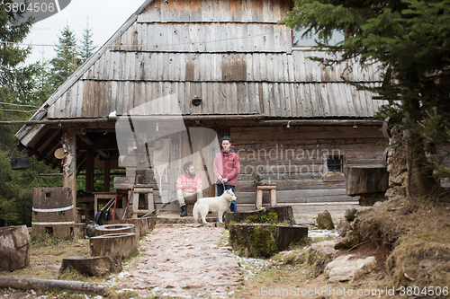 Image of frineds together in front of old wooden house