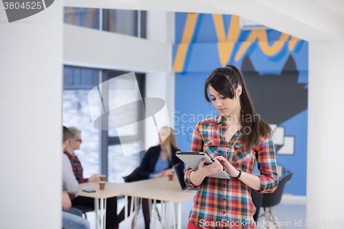 Image of portrait of young business woman at office with team in backgrou