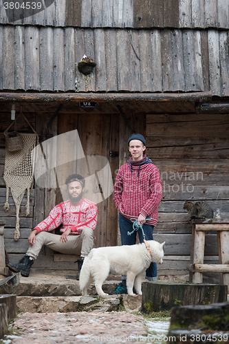 Image of frineds together in front of old wooden house