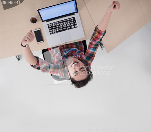 Image of top view of young business woman working on laptop