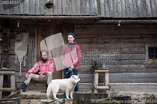 Image of frineds together in front of old wooden house