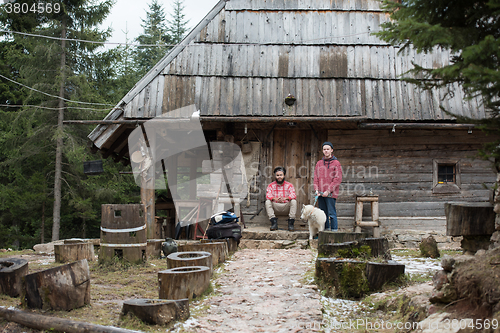 Image of frineds together in front of old wooden house