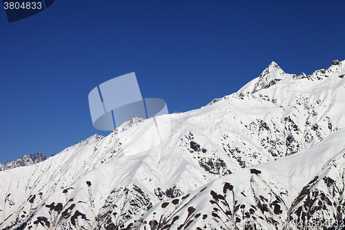 Image of Snowy mountain peaks and blue clear sky
