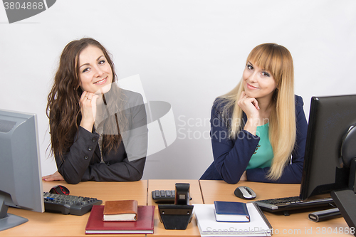 Image of Two young girls newly recruited developing are in the workplace