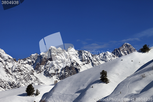 Image of Off-piste slope with track from ski and snowboard on sun day