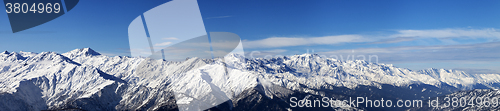 Image of Large panoramic view on snowy mountains in sunny day