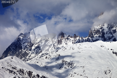 Image of Snowy rocks in haze at sunny day