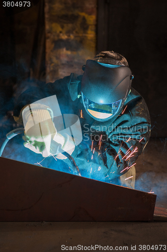 Image of worker welding metal