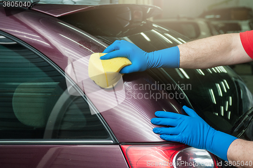 Image of washing car with sponge