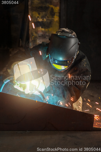 Image of worker welding metal