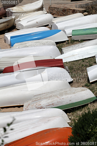 Image of  pile rowing boats on the shore