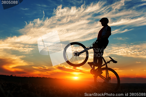 Image of Silhouette of a man on muontain-bike
