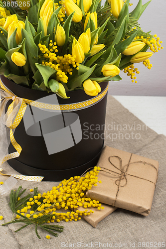 Image of Bright spring bouquet of tulips and mimosa flowers