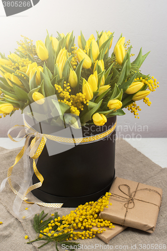 Image of Bright spring bouquet of tulips and mimosa flowers