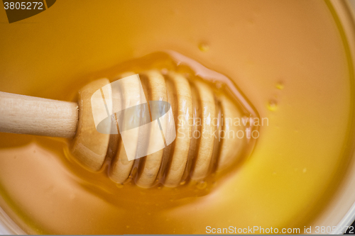 Image of Honey with wooden spoon