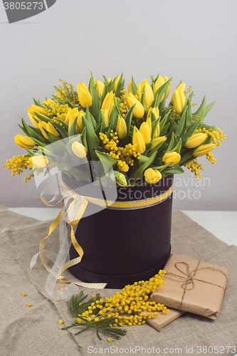 Image of Bright spring bouquet of tulips and mimosa flowers