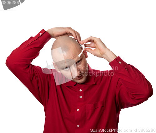 Image of Young man puts on head headset EEG (electroencephalography)