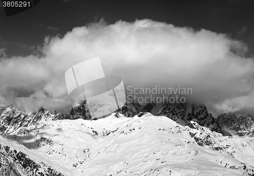 Image of Black and white view on Mount Ushba in clouds at winter