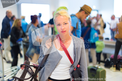 Image of Female traveller waiting in airport terminal.