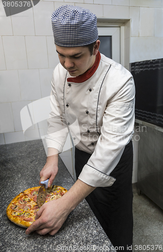 Image of Chef Cutting the Pizza
