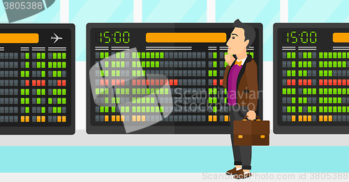 Image of Man looking at schedule board.