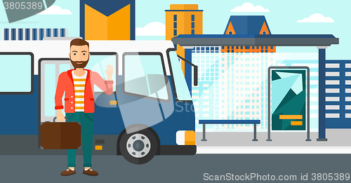 Image of Man standing near bus.