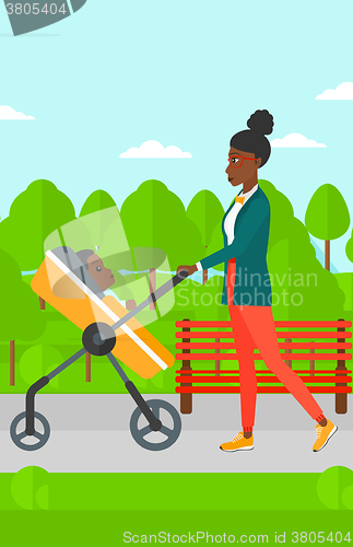 Image of Woman pushing pram.