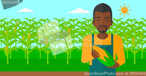 Image of Farmer holding corn.